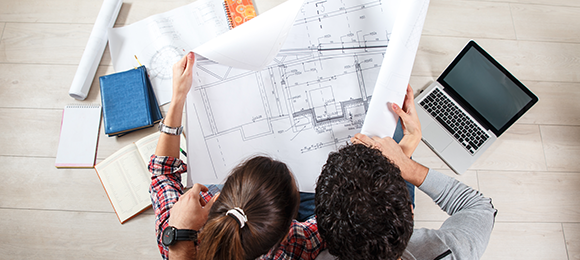 couple looking over blueprint