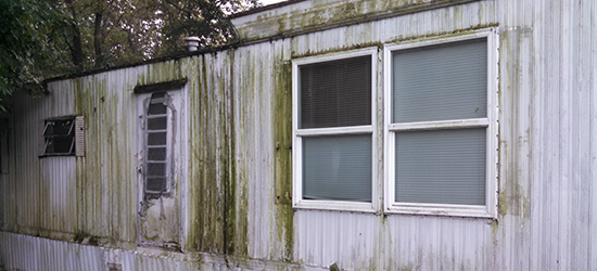 old water stained mobile home