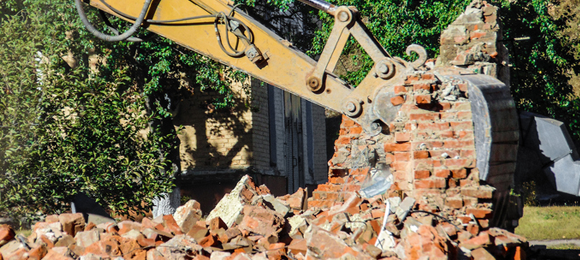 excavator picking up bricks