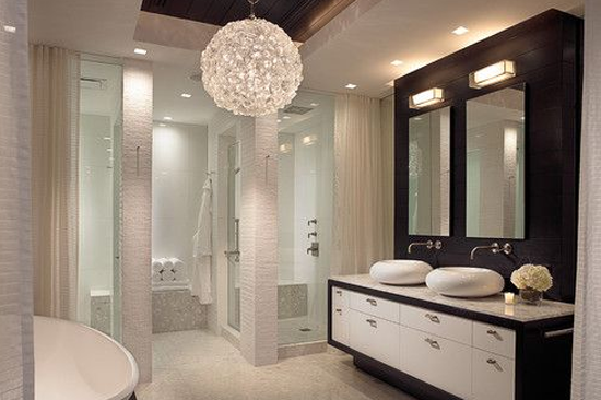 Large circular modern lighting fixture in bathroom