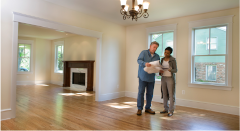 contractor going over plans with woman in home