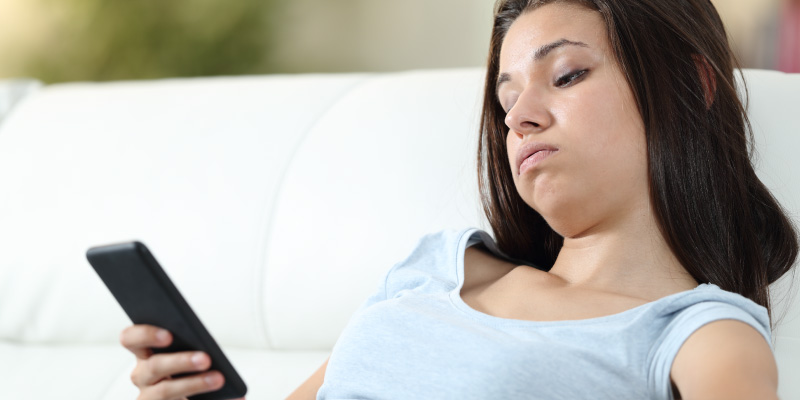 woman procrastinating on phone