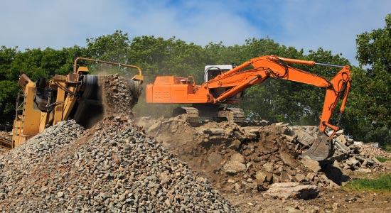 excavator demolishing concrete