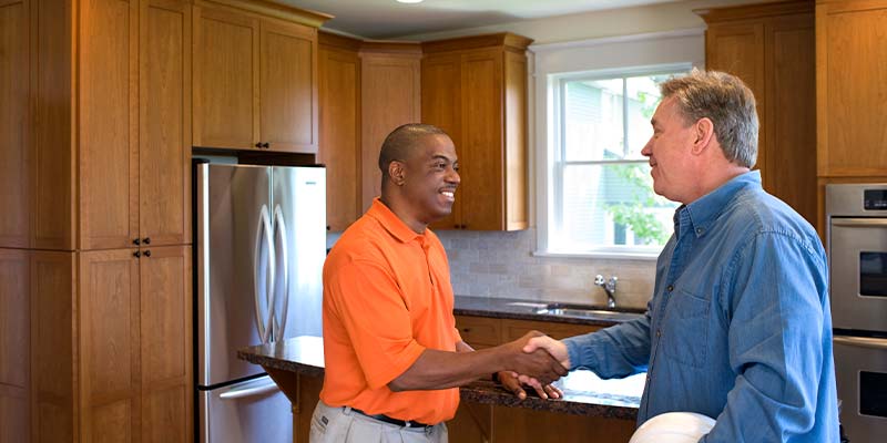 homeowner and demolition contractor shaking hands