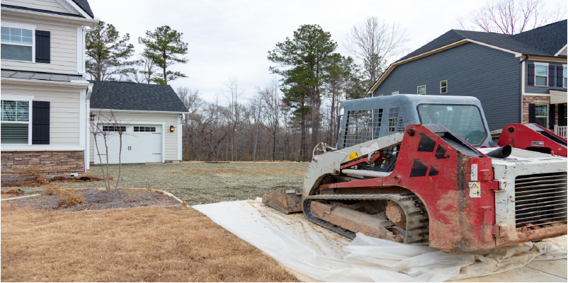 Bobcat working on driveway replacement